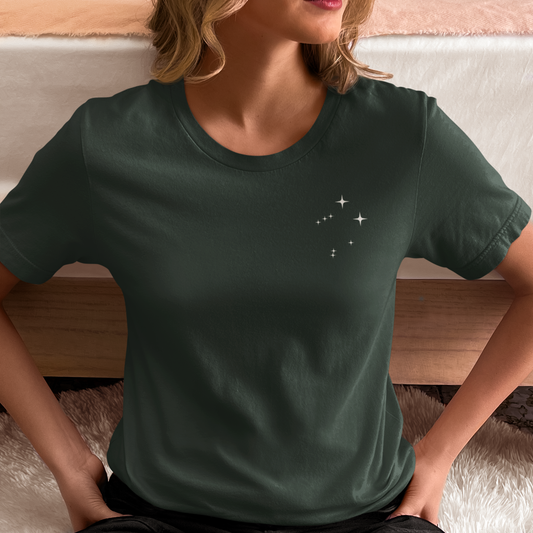 Woman wearing a forest t-shirt with Libra constellation stars.