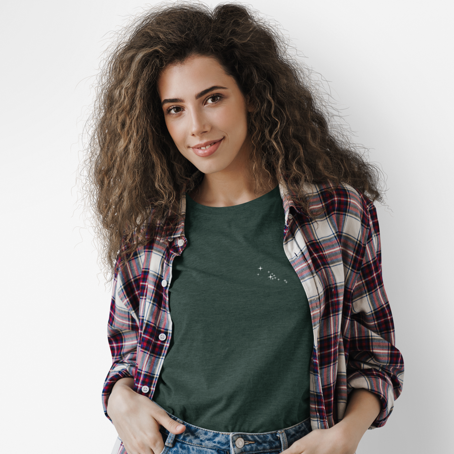 Woman wearing a green Taurus constellation t-shirt and plaid shirt with a plain background