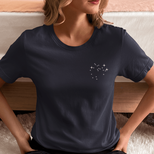 Woman wearing a navy blue Sagittarius constellation t-shirt.