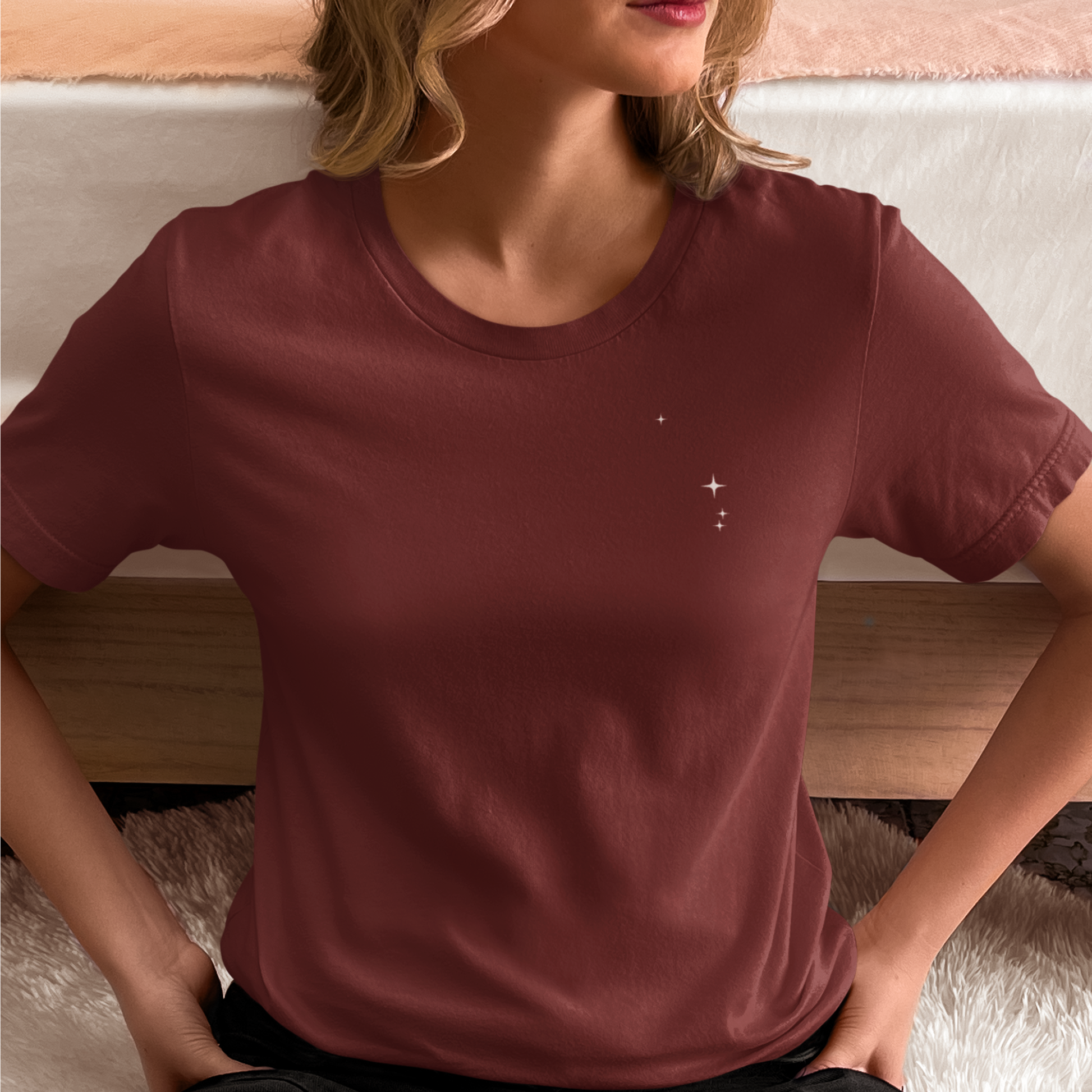 Woman wearing a cardinal t-shirt with Aries constellation stars.