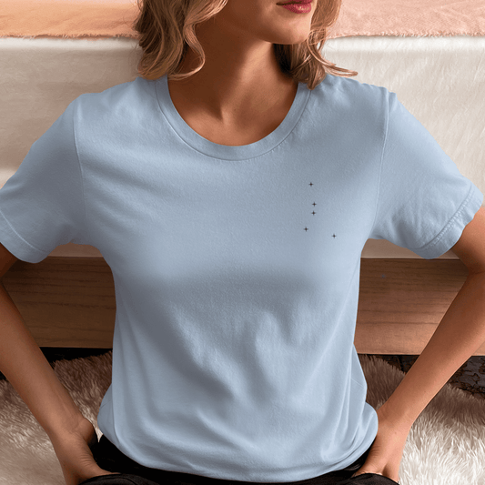 Woman wearing a light blue t-shirt with constellation stars