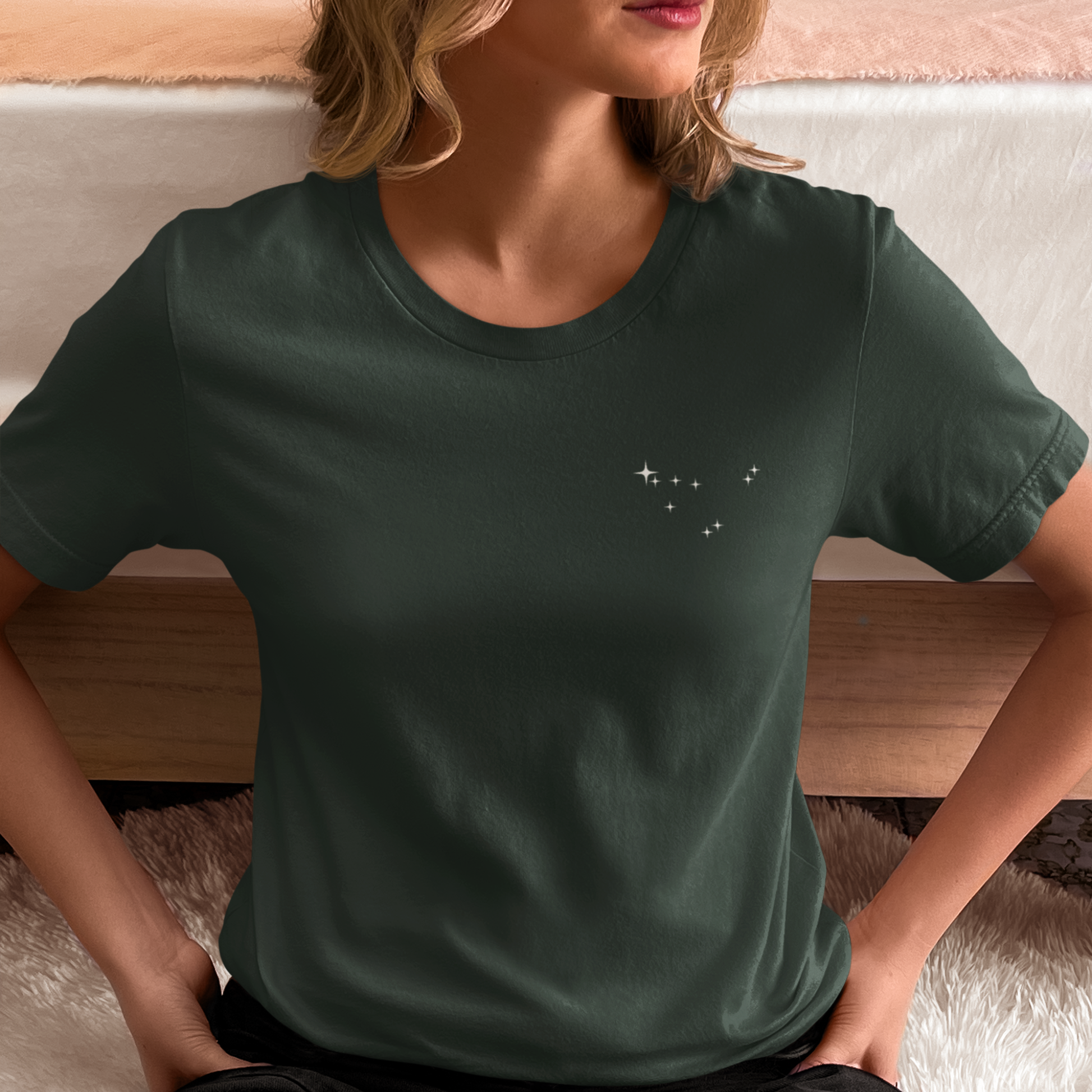 Woman wearing a forest t-shirt with Capricorn constellation stars.