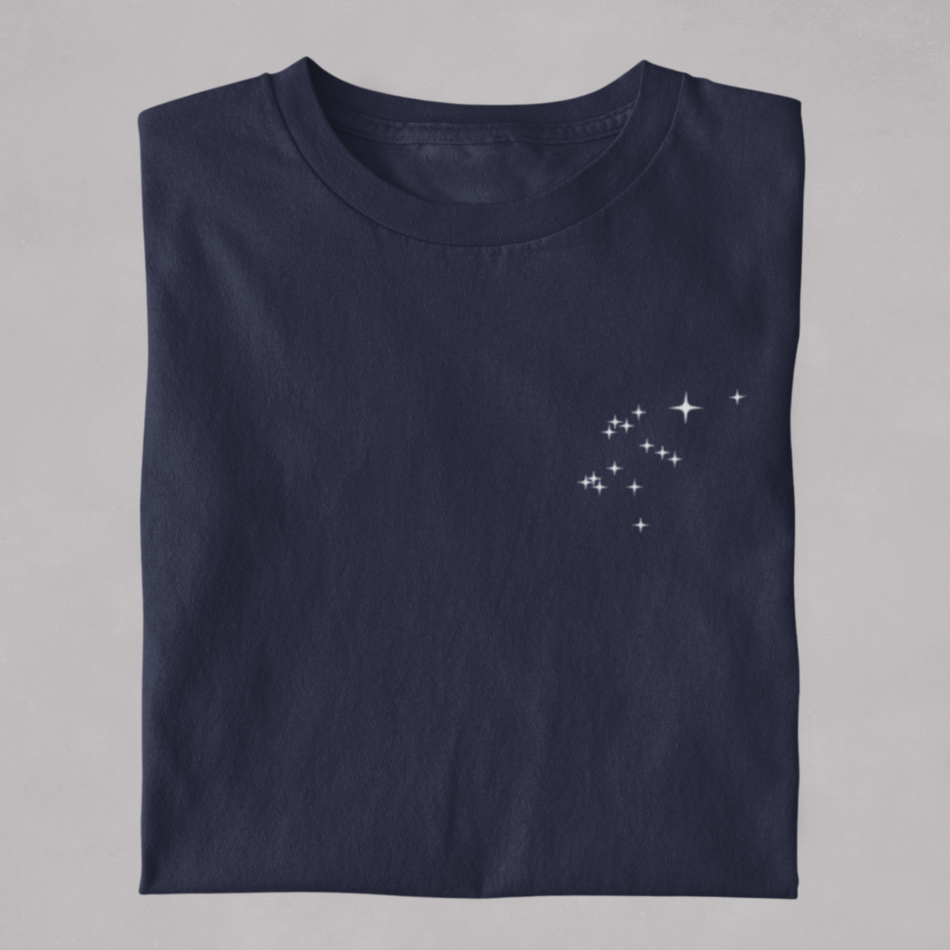 Folded  t-shirt with the Aquarius constellation design on a white background.