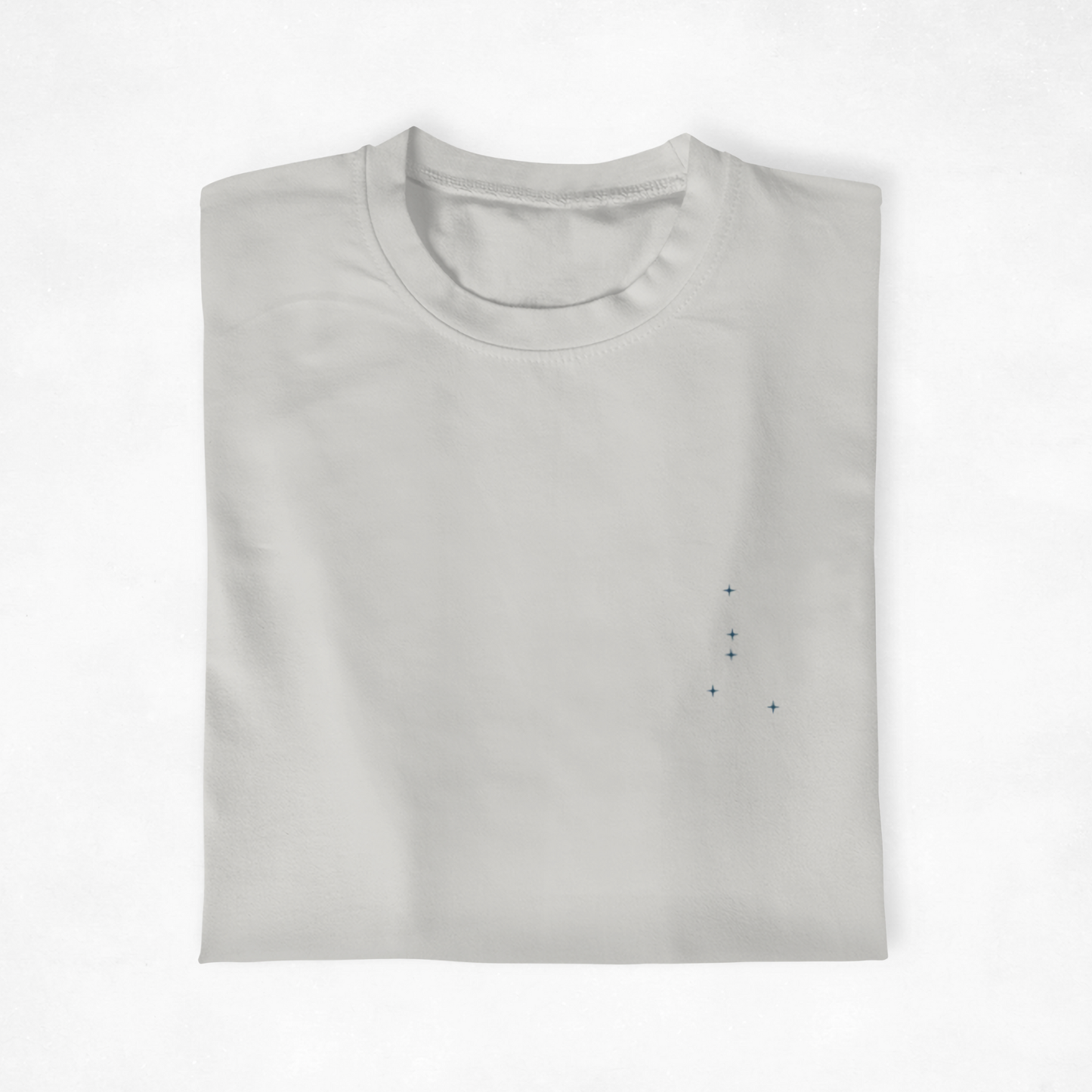 Folded  t-shirt with the Cancer constellation design on a white background.