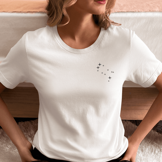 Woman wearing a white t-shirt with Gemini constellation stars.