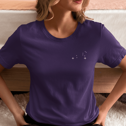 Woman wearing a purple t-shirt with Leo constellation stars.