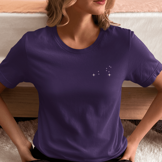 Woman wearing a purple t-shirt with Leo constellation stars.
