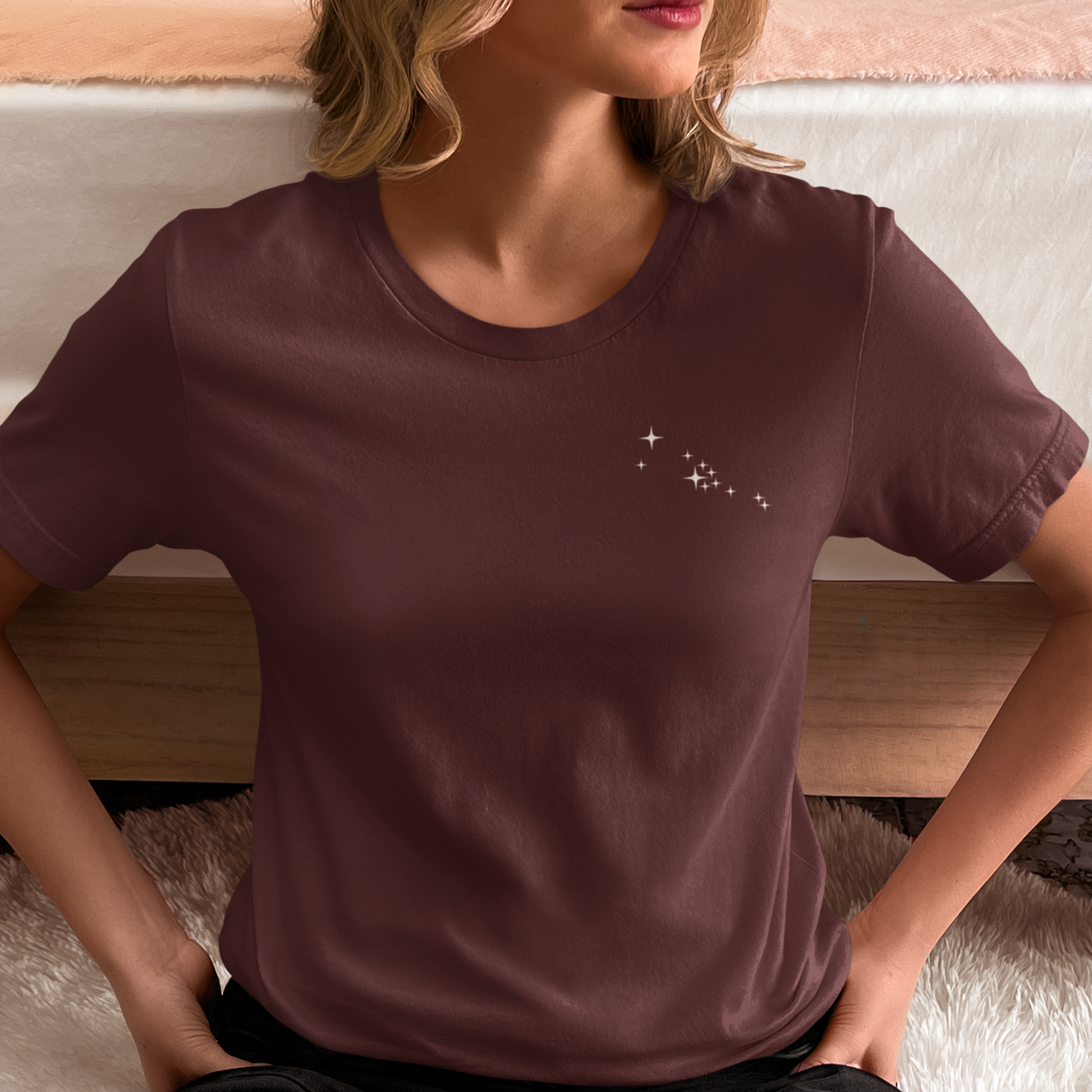 Woman wearing a Taurus constellation t-shirt on a neutral background